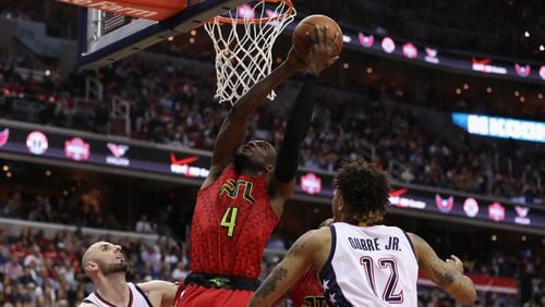 Paul Millsap of the Atlanta Hawks puts up a shot between Marcin Gortat and Kelly Oubre Jr. of the Washington Wizards in the second half in Game 5 of the Eastern Conference quarterfinals at Verizon Center on April 26, 2017 in Washington, DC. (Photo by Rob Carr/Getty Images)
