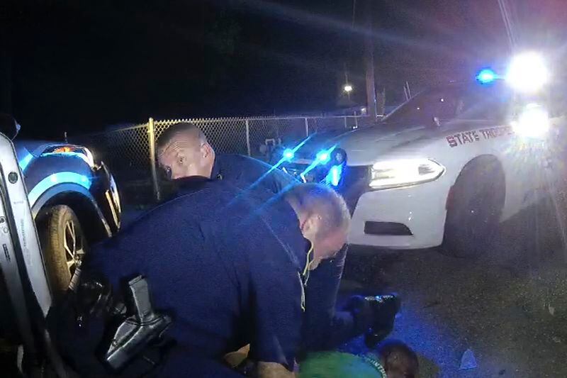 This image from video from Louisiana state trooper Lt. John Clary's body-worn camera shows troopers holding Ronald Greene on his stomach on May 10, 2019, outside of Monroe, La. The video obtained by The Associated Press shows Louisiana state troopers stunning, punching and dragging the Black man as he apologizes for leading them on a high-speed chase. (Louisiana State Police via AP)