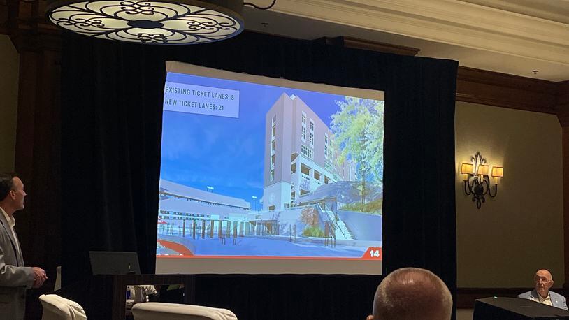 Matt Brachowski (L) shows a rendition of the new southside tower addition to the south side of Sanford Stadium during a slide-show presentation to the UGA Athletics board Thursday at the Ritz Carlton Lodge at Lake Oconee in Greensboro. (Photo by Chip Towers/ctowers@ajc.com)