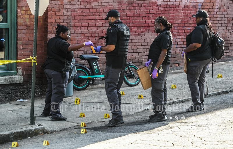 Police collect evidence from the scene of a double shooting in Atlanta's Sweet Auburn neighborhood.