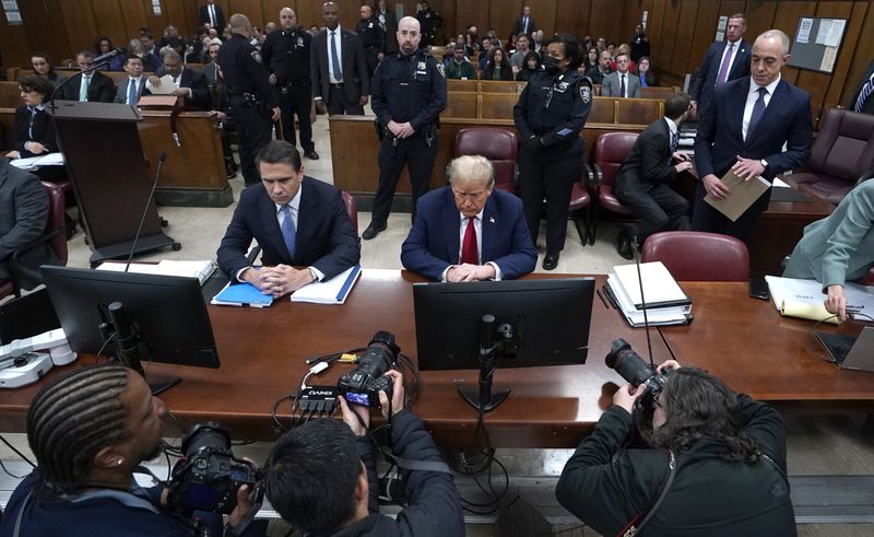 Former US President Donald Trump, with lawyer Todd Blanche, left, attends his trial for allegedly covering up hush money payments linked to extramarital affairs, at Manhattan Criminal Court in New York City, Tuesday April 23, 2024. Before testimony resumes Tuesday, the judge will hold a hearing on prosecutors' request to sanction and fine Trump over social media posts they say violate a gag order prohibiting him from attacking key witnesses. (Timothy A. Clary/Pool via AP)