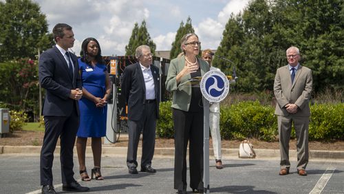U.S. Rep. Carolyn Bourdeaux speaks Friday during a visit to Peachtree Corners with U.S. Transportation Secretary Pete Buttigieg, left, in front of City Hall.  (Alyssa Pointer/Atlanta Journal Constitution)