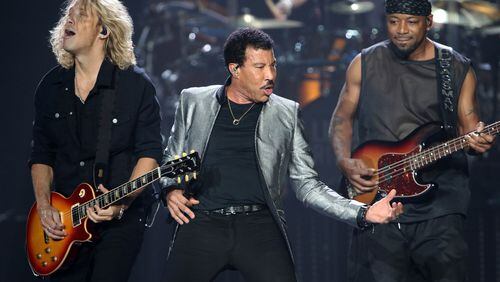 Lionel Richie, along with guitarist Ben Mauro and bassist Ethan Farmer, put some zip into "Running With the Night." Photo: Photo: Robb Cohen Photography & Video /RobbsPhotos.com