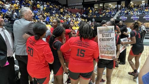 Clinch County players and coaches celebrate their 45-42 victory over Lake Oconee Academy in the Class A Division II girls basketball championship game at the Macon Coliseum on March 8, 2023.