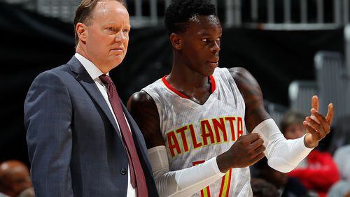 Hawks coach Mike Budenholzer instructs point guard Dennis Schroder during a preseason game this month. (Photo by Kevin C. Cox/Getty Images)