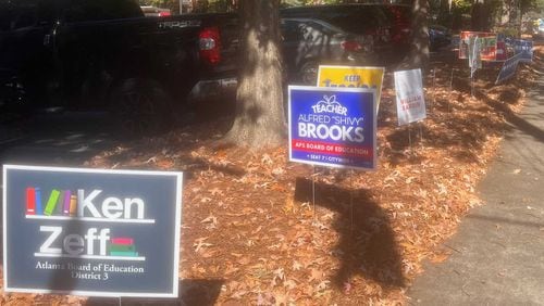 Campaign signs for various 2023 Atlanta school board candidates are lined up near an early voting location on Ponce de Leon Avenue in Midtown Atlanta. (Eric Stirgus / eric.stirgus@ajc.com)