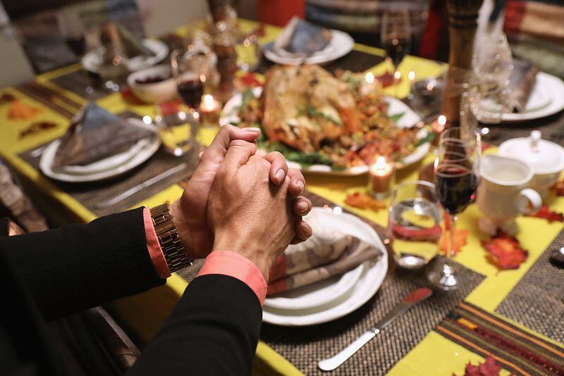   Central American immigrants and their families pray before Thanksgiving dinner on November 24, 2016 in Stamford, Connecticut. Family and friends, some of them U.S. citizens, others on work visas and some undocumented immigrants came together in an apartment to celebrate the American holiday with turkey and Latin American dishes. T  (Photo by John Moore/Getty Images)