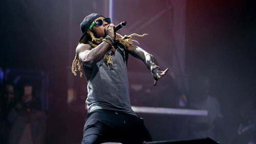 Lil' Wayne performs at at Music Midtown in 2016. AJC file photo: Akili-Casundria Ramsess/Special to the AJC