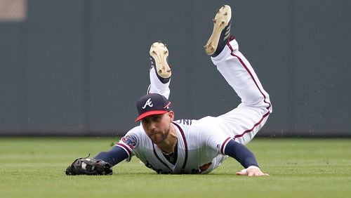 Atlanta Braves centerfielder Ender Inciarte makes a diving catch on a ball hit by New York Mets' Kevin Plawecki in the fifth inning of a baseball game in Atlanta, Sunday, Sept. 17, 2017. (AP Photo/Tami Chappell)