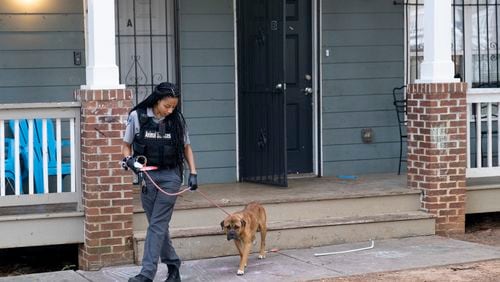 Fulton County Animal Services Field Service Supervisor Ladream Taylor leads an injured stray dog away from a person’s porch Thursday, Oct. 5, 2023 in Northwest Atlanta.   (Ben Gray / Ben@BenGray.com)