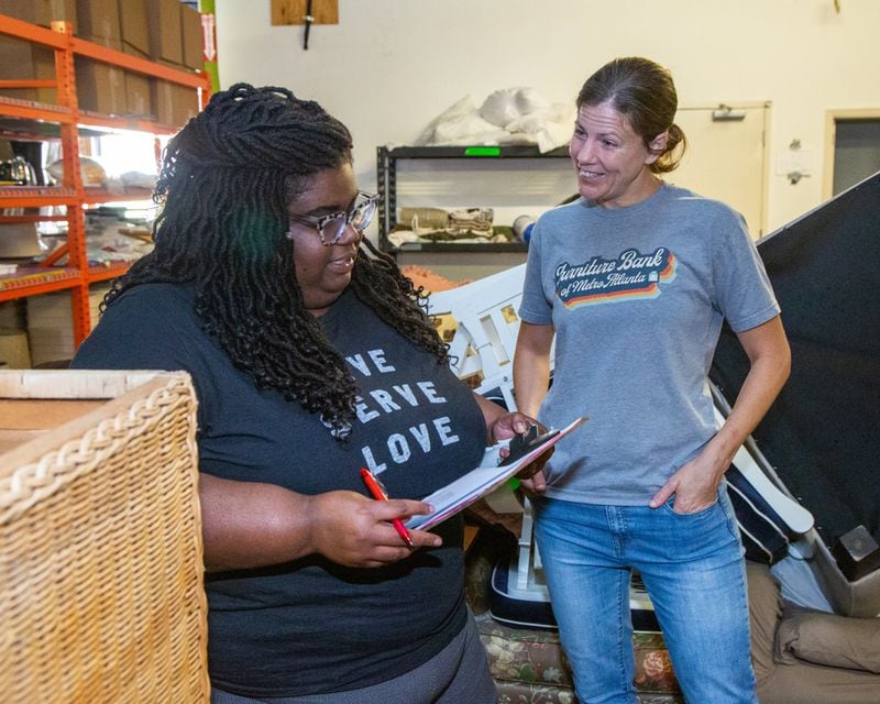 Client Service Manager Phenixx Adams (left) talks with Executive Director Megan Anderson at the Furniture Bank of Metro Atlanta. (Phil Skinner for The Atlanta Journal-Constitution)