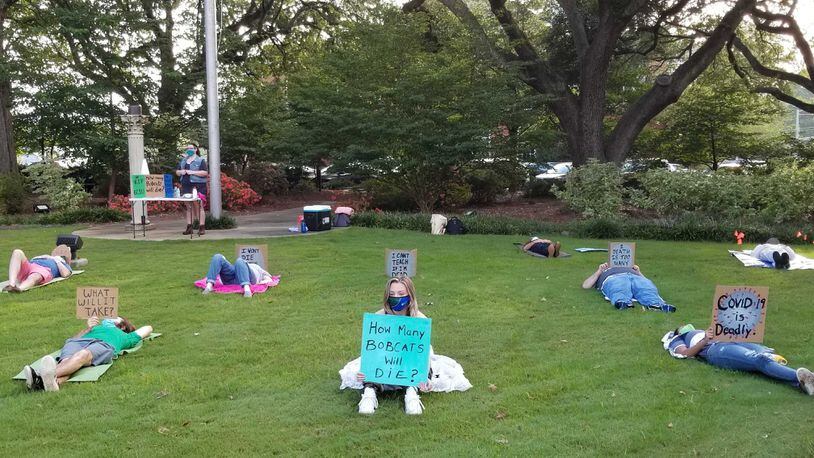 Protesters held a die-in at Georgia College on Friday, Aug. 28, 2020 to publicize demands, such as allowing any student and faculty to participate in classes remotely, to prevent the spread of COVID-19 on campus. Georgia College has reported more than 500 positive cases since it began tracking cases in mid-June. PHOTO CREDIT: United Campus Workers of Georgia - Georgia College