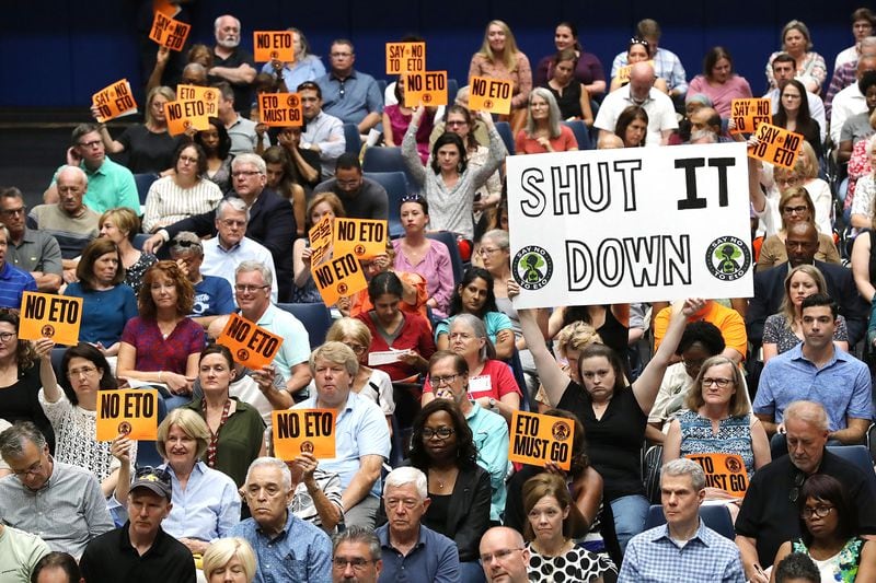 Many area residents hold signs in opposition to Sterigenics during a town hall held by Cobb officials and environmental regulators on Monday, August 19, 2019, in Marietta. Curtis Compton/ccompton@ajc.com