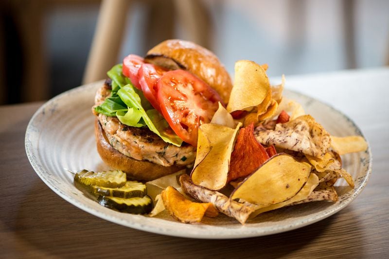 Hand Cut Salmon Burger with house bun, butter lettuce, remoulade, pickled veggies, and terra chips. Photo credit- Mia Yakel.