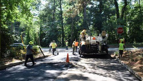 Crews pave Clearview Drive at North Druid Hills Road, one of the last streets to be paved this year.