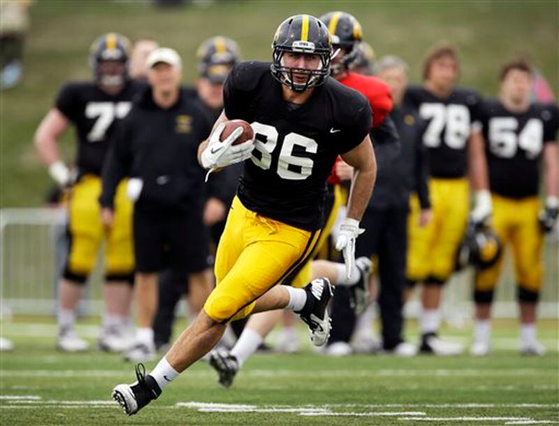 Iowa tight end C.J. Fiedorowicz runs with the ball after catching a pass during NCAA college football practice at Valley High School Stadium, Sunday, April 14, 2013, in West Des Moines, Iowa. (AP Photo/Charlie Neibergall) Iowa tight end C.J. Fiedorowicz runs with the ball after catching a pass during NCAA college football practice at Valley High School Stadium, Sunday, April 14, 2013, in West Des Moines, Iowa. (AP Photo/Charlie Neibergall)