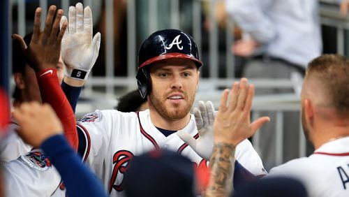 Hot-hitting first baseman Freddie Freeman was out of the Braves lineup Saturday due to a stomach virus.