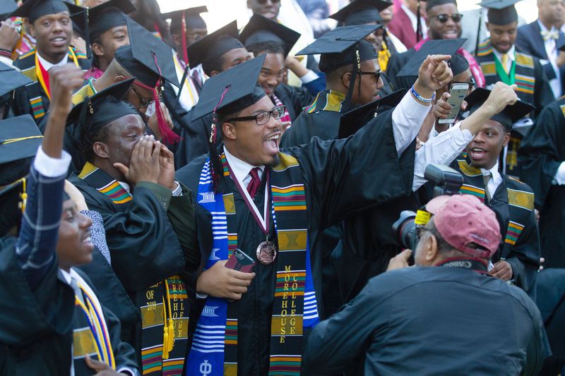 Graduates react after hearing billionaire Robert F. Smith is paying all student debt for the Class of 2019 during the Morehouse College graduation ceremony in Atlanta on Sunday, May 19, 2019. 