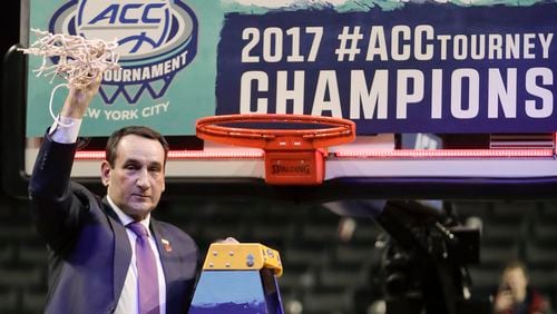 Duke Blue coach Mike Krzyzewski holds his piece of the net after Duke beat Notre Dame 75-69 in the championship game of the ACC Tournament on Saturday, March 11, 2017, in New York. (AP Photo/Julie Jacobson)