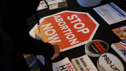 A person looks at materials at the National Right to Life booth at the National Right to Life Convention at the Airport Marriott Hotel in Atlanta on Friday, June 24, 2022. (Arvin Temkar / arvin.temkar@ajc.com)