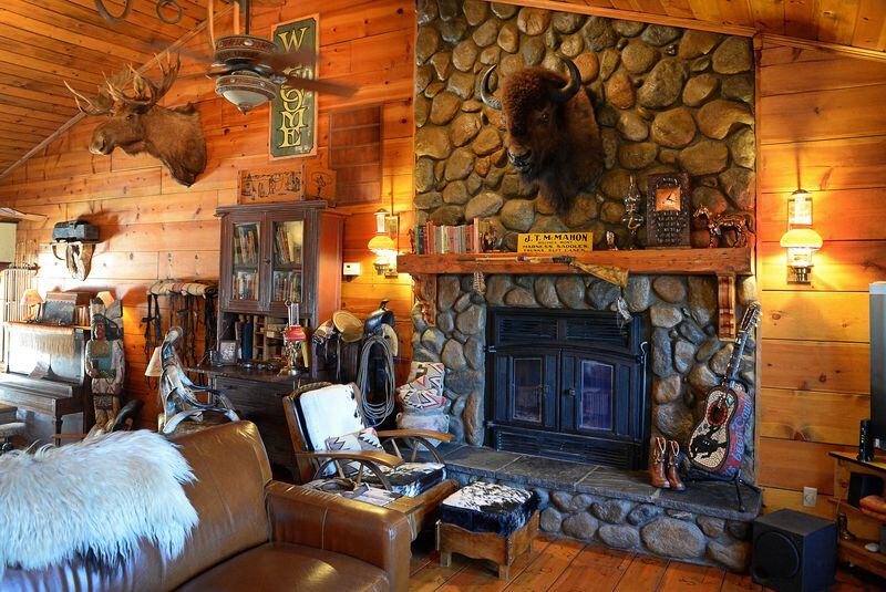 The great room at Karen Perez's Hanford home has the appearance of a mountain lodge, featuring a rock fireplace and large taxidermy pieces of different animals, as seen on Wednesday, Sept. 27, 2017. (Craig Kohlruss/Fresno Bee/TNS)
