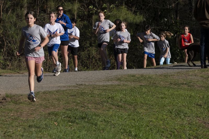 Kids with the Walton Youth Running Club work out in Marietta on Thursday, March 28, 2024.   (Ben Gray / Ben@BenGray.com)