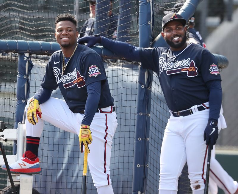 Braves outfielders Ronald Acuna and Marcell Ozuna share a laugh during batting practice before playing the Minnesota Twins Friday, March 5, 2021, at CoolToday Park in North Port, Fla. (Curtis Compton / Curtis.Compton@ajc.com)