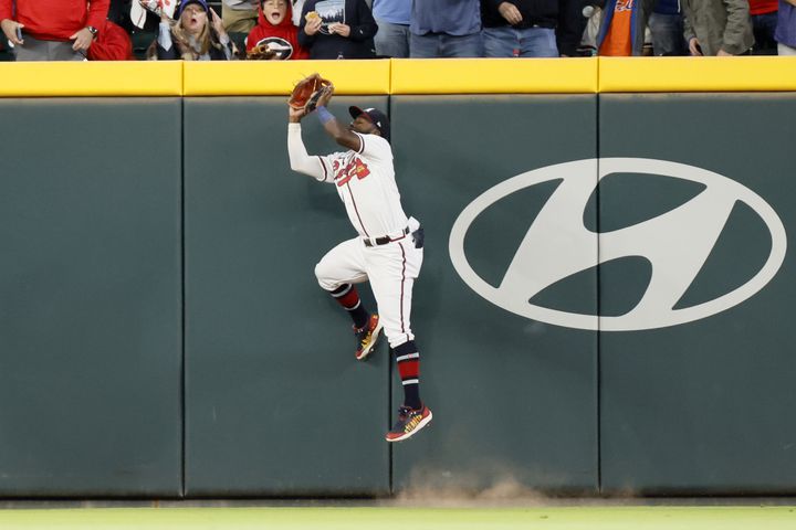 Atlanta Braves center fielder Michael Harris II (23) jumps against the fence to catch the ball during the second inning at Truist Park on Saturday, Oct. 1, 2022. Miguel Martinez / miguel.martinezjimenez@ajc.com