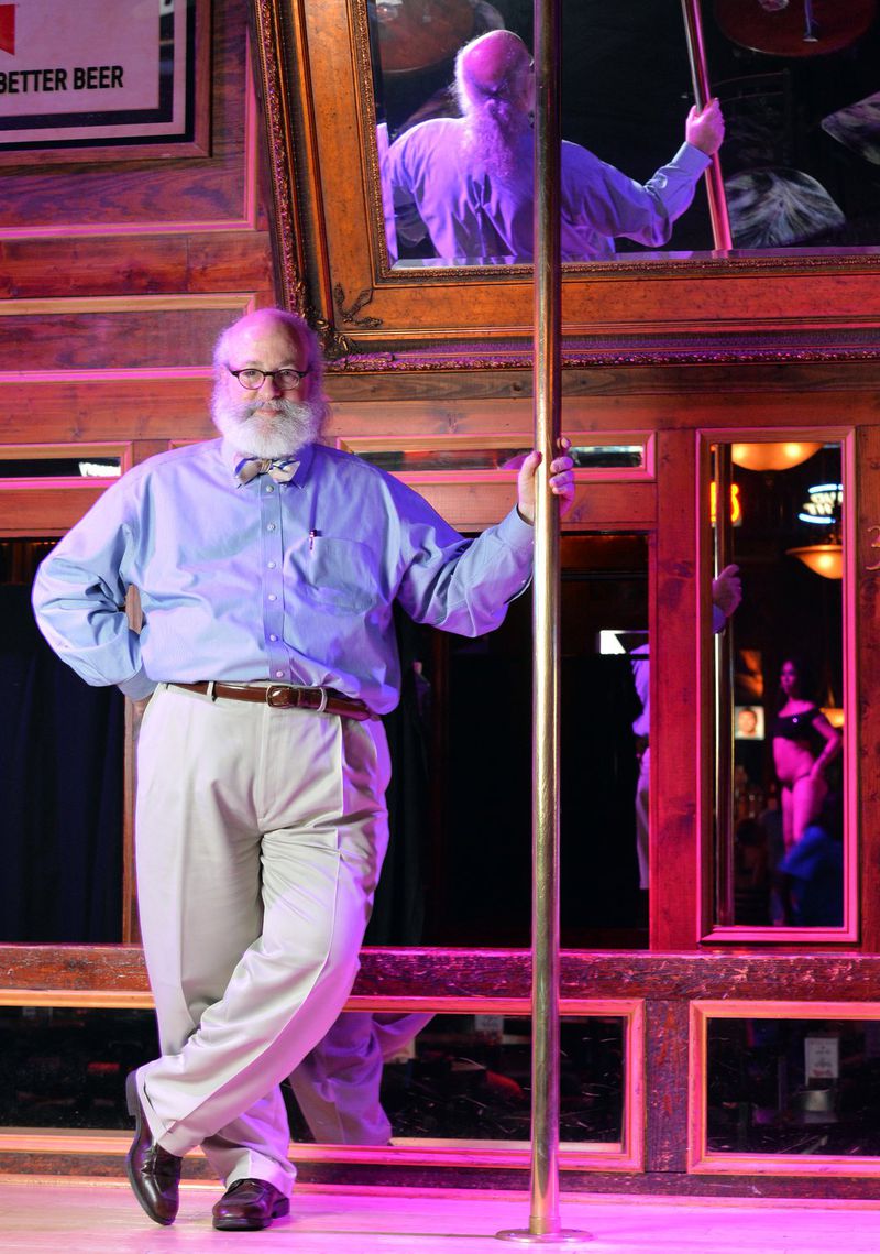Alan Begner, the lawyer who represents most of the strip clubs in Atlanta, holds a pole on stage at Oasis Goodtime Emporium in 2013. HYOSUB SHIN / HSHIN@AJC.COM