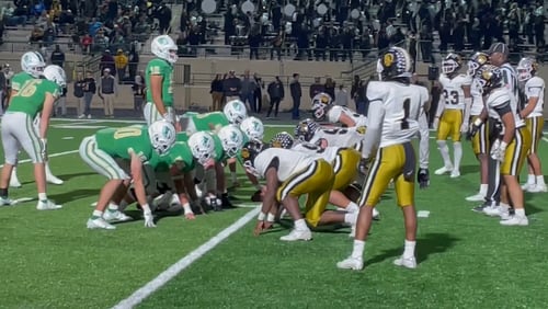 Buford quarterback Ashton Daniels (12) brings his team to the line for the final snap of the Wolves' 21-6 victory over Carrollton in the Class 6A semifinals on Dec. 3, 2021.