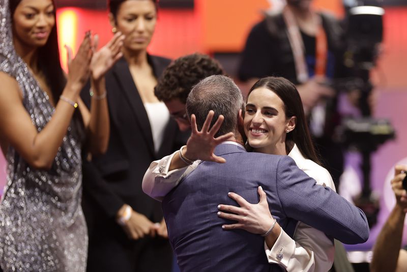 Iowa's Caitlyn Clark hugs her father, Brent Clark, after being selected first overall by the Indiana Fever during the first round of the WNBA basketball draft, Monday, April 15, 2024, in New York. (AP Photo/Adam Hunger)