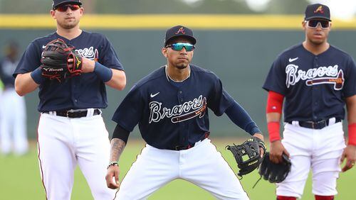 Austin Riley (from left), Johan Camargo and Yangervis Solarte get in some work at third base during Wednesday's activities. (Curtis Compton/ccompton@ajc.com)
