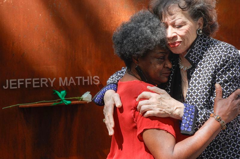 (Left to right) Valerie Mathis, the sister of victim Jeffery Mathis embraces Valerie Jackson, the widow of former Atlanta Mayor Maynard Jackson in front of Atlanta Children’s Eternal Flame Memorial on Tuesday, June 27, 2023. The memorial was created to honor the lives of children killed during the Atlanta Child Murders. (Natrice Miller/ Natrice.miller@ajc.com)