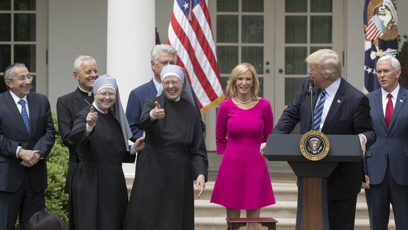 Nuns with the Little Sisters of the Poor give a thumbs up at a National Day of Prayer event with President Donald Trump and other religious leaders in the Rose Garden at the White House, in Washington, May 4, 2017. At the event Trump signed an executive order aimed at easing restrictions on political activity by tax-exempt churches and charities. (Stephen Crowley/The New York Times)