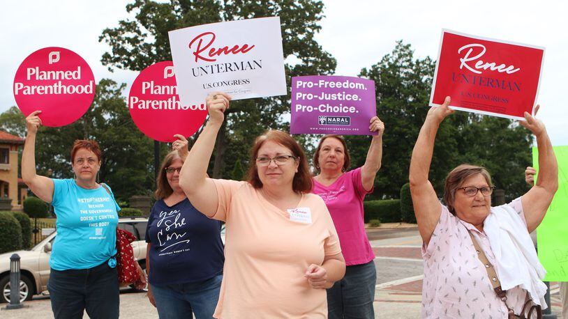 Supporters of state Sen. Renee Unterman’s bid for Congress stand in front of volunteers from Planned Parenthood who attended the state legislator’s campaign launch to protest her part in passage of Georgia’s new anti-abortion “heartbeat” law. (Christina Matacotta/christina.matacotta@ajc.com)