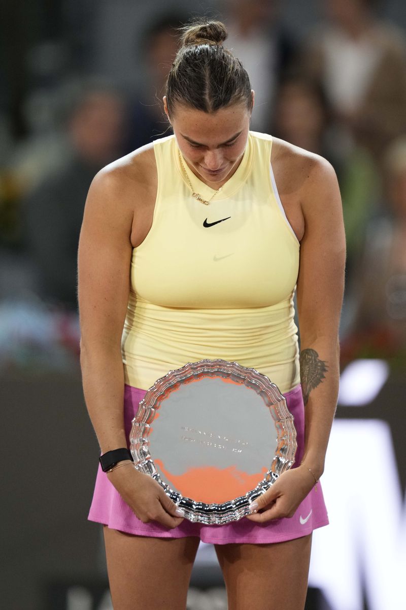 Aryna Sabalenka of Belarus holds her trophy after loosing against Poland's Iga Swiatek in the women's final match against at the Mutua Madrid Open tennis tournament in Madrid, Spain, Saturday, May 4, 2024. (AP Photo/Bernat Armangue)