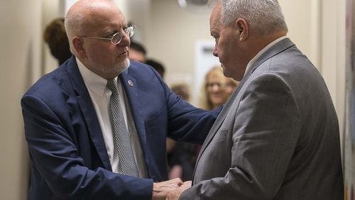 Director of the Centers for Disease Control and Prevention, Dr. Robert Redfield (left), shakes hands with Larry Lehman, CEO and President of the Positive Impact Health Centers, during a tour of the Positive Impact Health Center in Decatur.(ALYSSA POINTER/ALYSSA.POINTER@AJC.COM)