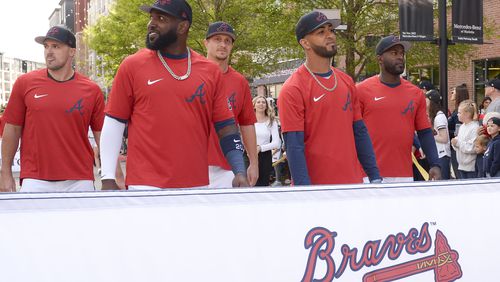 Braves outfielders Adam Duvall (from left), Marcell Ozuna, Alex Dickerson, Eddie Rosario and Guillermo Heredia walk the parade route during opening-day festivities Thursday at The Battery. Dickerson went hitless in the opening series against the Reds despite hitting several balls hard. (Daniel Varnado/for The Atlanta Journal-Constitution)