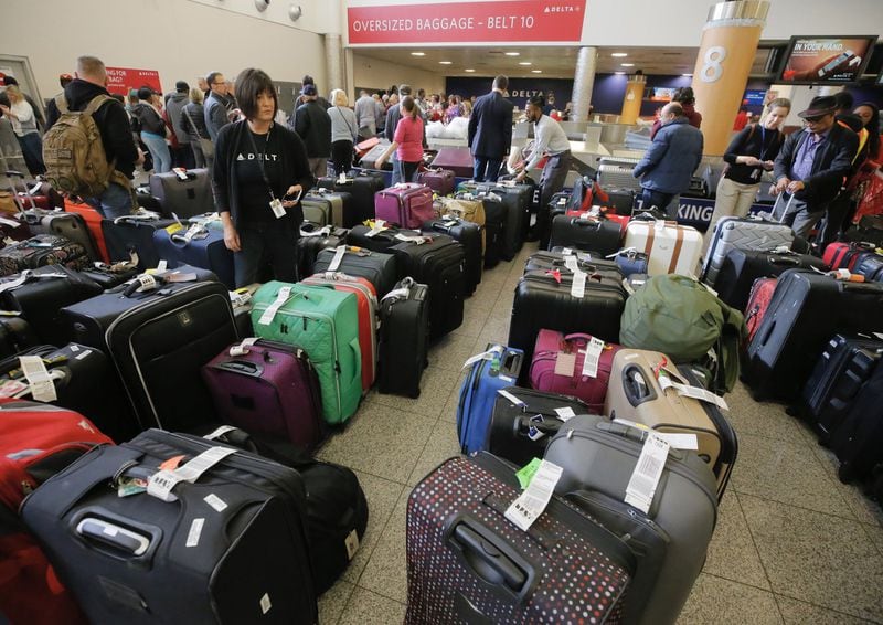 Passengers were still feeling the effects of Sunday’s power outage at Hartsfield-Jackson International Airport as they had to endure long lines to claim baggage and ride shuttles. BOB ANDRES /BANDRES@AJC.COM