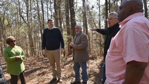 (From left) Bobbie Hart, Wesley Edwards, Michael Bowen, Gene Bowen and Mike Merideth visit the Troup County site where Austin Callaway was found bleeding to death from gunshot wounds in 1940. Their organization, Troup Together, has been researching Callaway’s lynching and working to promote racial dialogue in the county. HYOSUB SHIN / HSHIN@AJC.COM