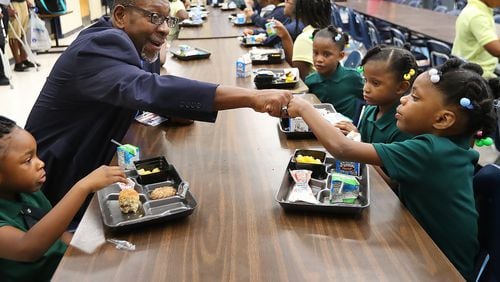 DeKalb school Superintendent Steve Green gives 6-year-old kindergarten student Lanyah Bailey a fist bump during the first day of school at last year.  Milestones test results were just released, letting schools know how they are doing in key educational issues. Curtis Compton/ccompton@ajc.com