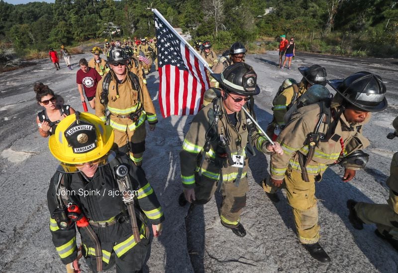 Local firefighters begin the climb to the top of Stone Mountain on Sept. 11, 2019.