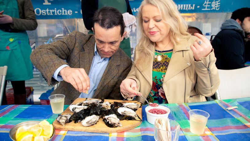 A couple samples oysters at a cafe in the Temple Bar Market. (Tourism Ireland)