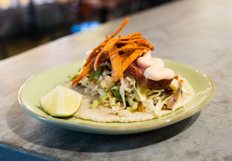 The seared tuna taco at Babalu comes with a spicy crema sauce and crunchy tortilla strips. CONTRIBUTED BY HENRI HOLLIS