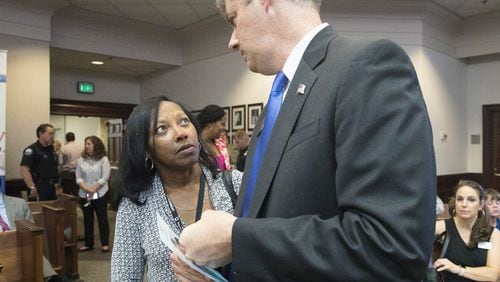 Lynnette Allen (left), Fulton County’s new opioid coordinator, speaks with Fulton Commissioner Bob Ellis (right) before the start of an opioid crisis forum in the Roswell City Council Chambers, Tuesday, June 26, 2018. ALYSSA POINTER/ALYSSA.POINTER@AJC.COM