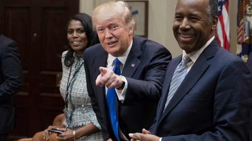 WASHINGTON, DC - FEBRUARY 1: President Donald Trump holds an African American History Month listening session attended by nominee to lead the Department of Housing and Urban Development (HUD) Ben Carson (R), Director of Communications for the Office of Public Liaison Omarosa Manigault (L) and other officials in the Roosevelt Room of the White House on February 1, 2017 in Washington, DC. (Photo by Michael Reynolds - Pool/Getty Images)