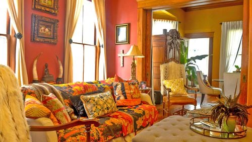 English said she painted her family room red because it represents happiness and good luck. The lively wall color is echoed in the Indian blankets that cover her custom sofa.