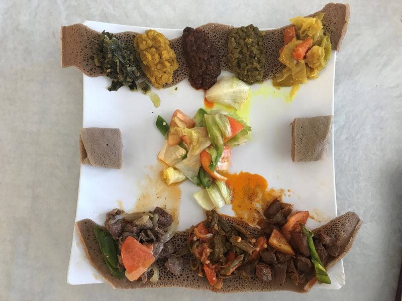 The Single Order Sampler is an excellent way to taste a variety of dishes at Bole Ethopian Restaurant. The sampler includes portions of Bole tibs, Bole awaze tibs and numerous vegetable and lentil preparations atop injera bread. LIGAYA FIGUERAS / LFIGUERAS@AJC.COM