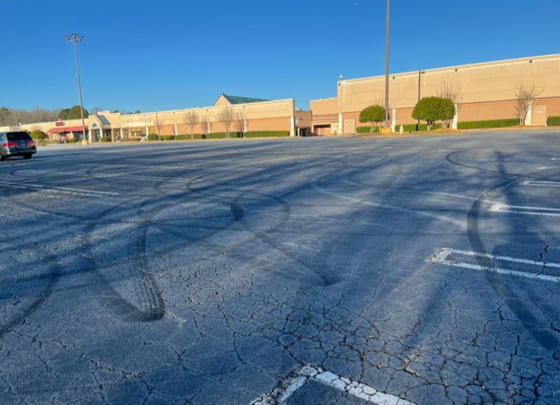 The massive and forlorn parking lot of the nearly deserted North DeKalb Mall has been the site of street racers laying tracks. Photo by Bill Torpy