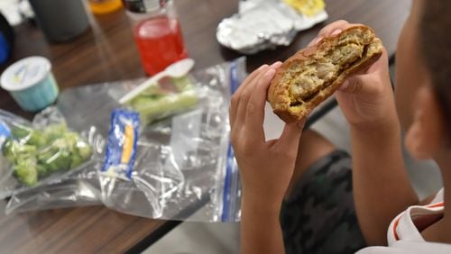 A student eats his lunch during summer camp at Campbell Middle School in Smyrna. School is over and that means many students run the risk of going hungry. Without schools providing meals — sometimes twice a day — some students won’t have the food at home. HYOSUB SHIN / HSHIN@AJC.COM